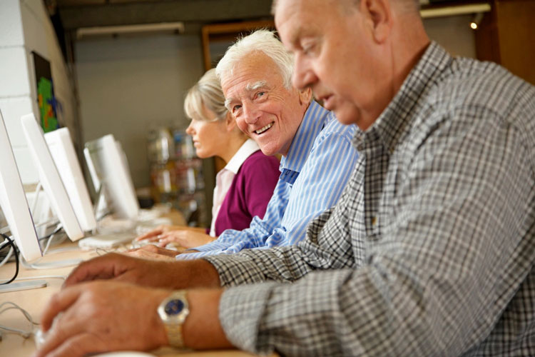 fm=f71726 A group of people sitting at tables with laptops.