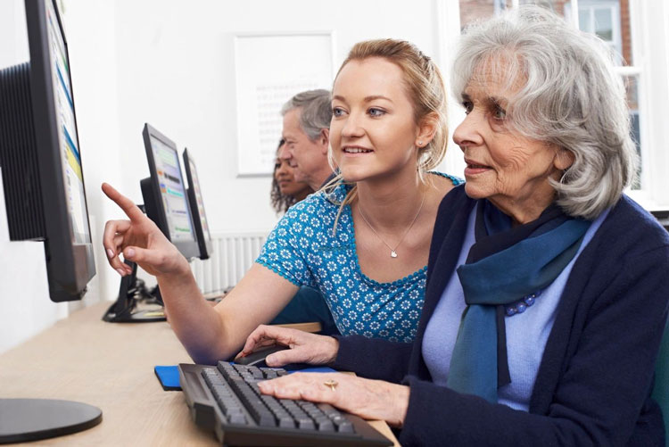 A woman and an older person using a tablet